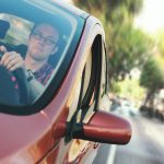 man driving the red vehicle