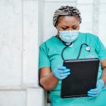focused woman with documents in hospital