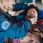 paramedic checking on man