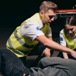 man and woman rescuing a person