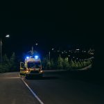 photo of an ambulance on the road at night